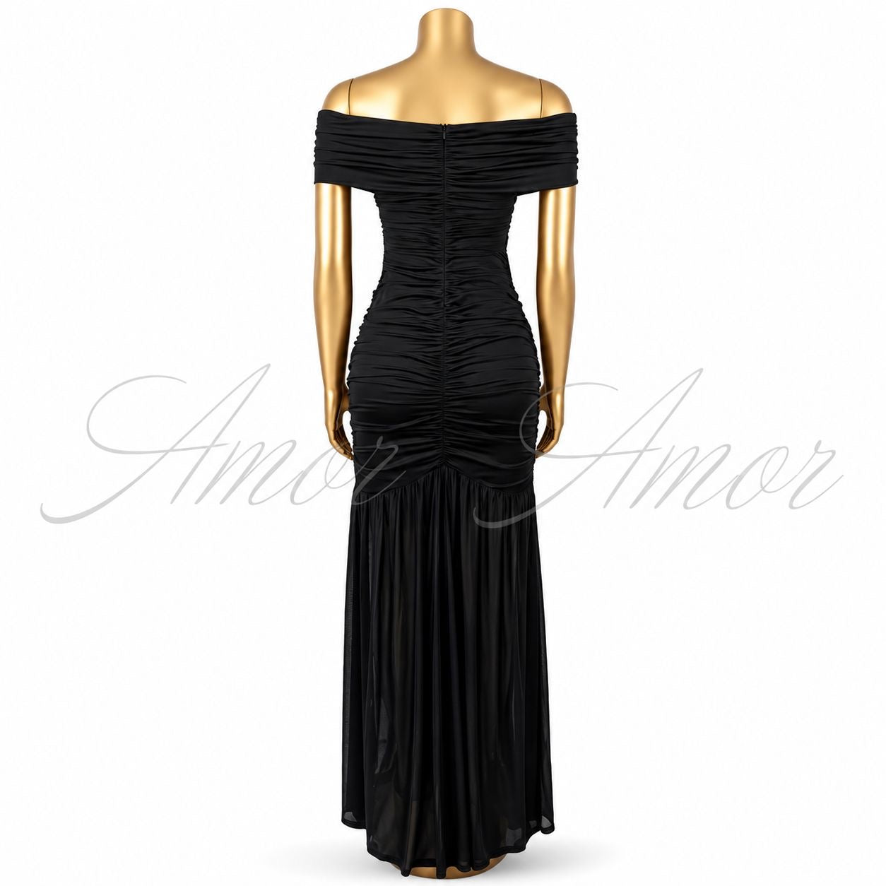 Vestido largo disponible en color negro, rojo y blanco. Diseño con hombros descubiertos, detalle metálico al frente, fruncido que estiliza la silueta y abertura en pierna. Elegante y sofisticado.